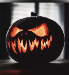 a carved pumpkin with scary teeth on it