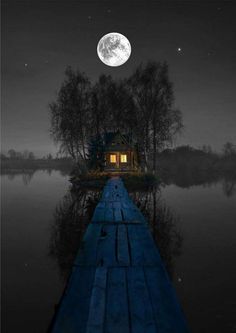 a wooden dock sitting next to a lake under a night sky