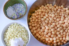 three bowls filled with different types of food on top of a white tablecloth next to each other