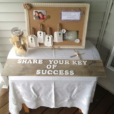 a table with a sign that says share your key to success on it and other items