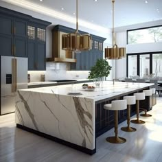 a large kitchen with marble counter tops and gold pendant lights hanging from the ceiling, along with bar stools