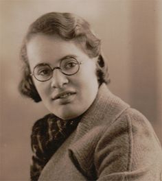 an old black and white photo of a woman wearing glasses