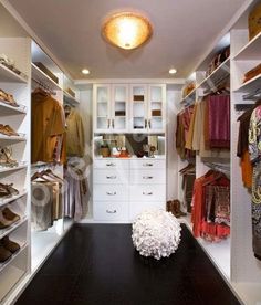 a walk in closet filled with lots of clothes