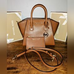 Authentic Michael Kors Avril Handbag With Removable Crossbody Strap And Wallet Set In A Gorgeous Saffiano Leather Color Called Camel Brown And Gold Hardware! This Set Is New Without Tags And Completely Blemish Free! Smoke Free Home And Fast Shipping! Offers Are Welcome Classic Brown Michael Kors Satchel, Michael Kors Brown Double Handle Satchel, Michael Kors Cognac Shoulder Bag For Everyday Use, Michael Kors Brown Satchel For Daily Use, Michael Kors Cognac Satchel Shoulder Bag, Michael Kors Brown Shoulder Bag With Detachable Handle, Michael Kors Brown Travel Satchel, Michael Kors Brown Satchel For Travel, Modern Brown Michael Kors Shoulder Bag