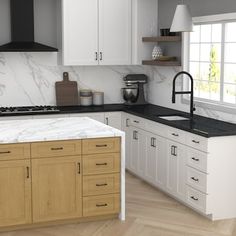 a kitchen with marble counter tops and white cabinets