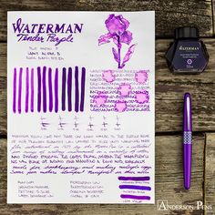 the fountain pen is next to some writing paper with ink on it and a purple flower