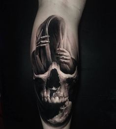 a man's leg with a skull tattoo on it and a person holding a knife