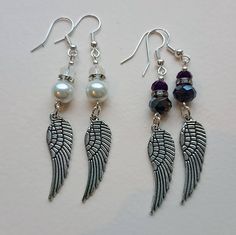 Embrace your light side or dark side with these angel wing earrings. Stylish look whatever your mood. With either white pearl and milky crystal, or midnight and dark iridescent purple, highlighted by coordinating diamonte rondelles. All components are nickel and lead free. Comes tissue wrapped in little organza gift bag and if purchased as a gift can be sent directly on request. Tulip Jewelry, Dark Iridescent, Diy Angel Wings, Angel Wing Bracelet, Angel Wings Jewelry, Cosplay Inspo, Blue Crafts, Iridescent Purple, Silver Angel Wings