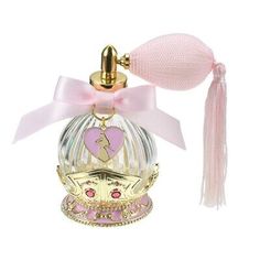 a small bottle with a pink ribbon around it and a gold crown on top that says i love you