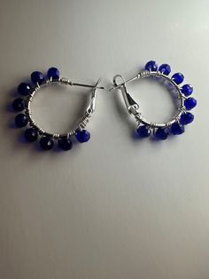 Sparkle and shine with these stunning blue glass crystal bead silver hoop earrings! Handcrafted to perfection, these earrings exude elegance and sophistication, making them the perfect accessory for any occasion. Elevate your style with the timeless beauty of blue glass crystals and silver hoops. Shop now in my Etsy store ✨ Blue Beaded Metal Hoop Earrings, Blue Nickel-free Hoop Earrings For Party, Adjustable Crystal Earrings With Faceted Beads, Blue Small Hoop Jewelry With Dangling Beads, Hoop Jewelry With Faceted Beads, Blue Small Hoop Earrings With Dangling Beads, Blue Wire Wrapped Hoop Beaded Earrings, Blue Small Hoop Earrings Wire Wrapped, Blue Small Hoop Earrings With Wire Wrapping