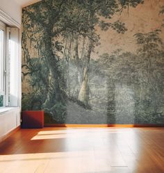 an empty room with wood floors and a wall mural on the wall that has trees painted on it