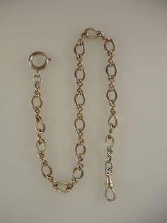 This is a yellow gold filled chain which measures 310mm from the dog clip to the bolt ring. The chain is made up of a single length of oval links decorated with fine engraving interspersed with two oval links. The chain is in 95% mint condition Classic Engraved Link Chain Bracelet, Classic Engraved Oval Link Chain Bracelet, Vintage Yellow Gold Chain Bracelet, Vintage Yellow Gold Oval Link Chain Bracelet, Classic Engraved Chain Link Bracelet, Vintage Engraved Chain Link Jewelry, Gold Engraved Oval Link Chain Bracelet, Vintage Gold Oval Link Chain Bracelet, Vintage 14k Gold Chain Link Bracelet