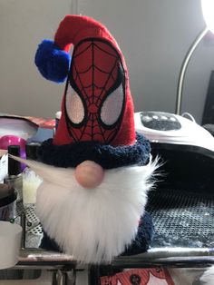 a close up of a stuffed animal wearing a spiderman hat