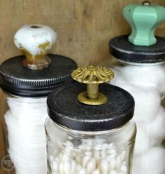 three jars filled with white cotton sitting next to each other