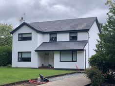 a large white house with a black roof