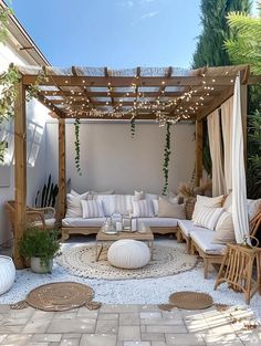 an outdoor living area with couches, tables and lights on the ceiling is shown