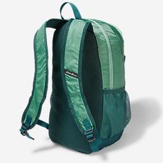 a green backpack with straps on the front and back side, sitting against a white background