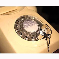 an old fashioned phone with keys attached to it