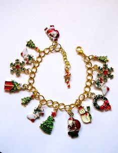 This charm bracelet has 15 enameled and gold-plated charms, including Christmas stockings, trees, snowflakes and more. It is an adjustable bracelet, able to be worn from 7 inches to 8 inches. This bracelet will be slipped into an organza bag and shipped in a bubble mailer. Christmas Bracelet, Christmas Accessories, Christmas Charms, Bubble Mailer, Santa Christmas, Organza Bags, Adjustable Bracelet, Charm Bracelets, Christmas Trees