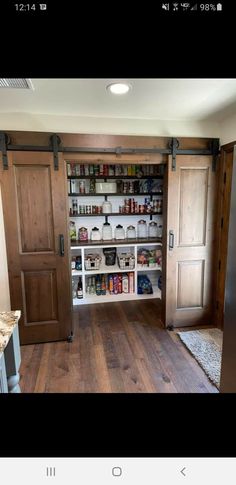 an open pantry with wooden doors and shelves