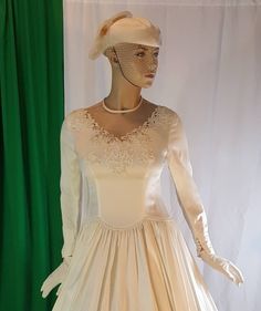 Stunning vintage Victorian/Edwardian style wedding gown in ivory. Dress fits best size small to medium Model is 5 foot 9 inches tall with bust of 36 inches Crinoline ,hat and gloves are  not included  Please send me a message if you have questions.  Color ivory  Fabric satin Beautiful lace and beads decorate the neckline transparent netting around neck See measurement on photos please Fitted Cream Victorian Ball Gown, Cream Victorian Ball Gown For Wedding, Victorian Ball Gown Dress For Wedding, Fitted Victorian Ball Gown For Wedding, Cream Victorian Wedding Dress With Fitted Bodice, Victorian Dress With Boned Bodice For Weddings, Fitted Cream Victorian Dress For Wedding, Fitted Wedding Dress With Lace Trim For Debutante Ball, Cream Gown For Vintage Events With Fitted Bodice