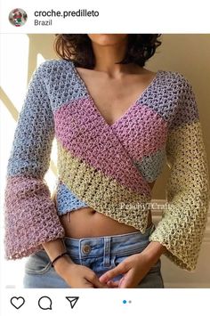 a woman is wearing a crocheted top and jeans