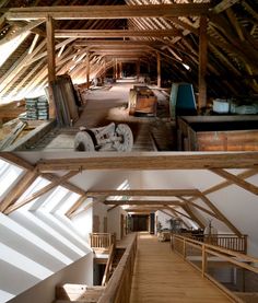 the inside of a building with wooden floors and beams