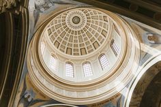 the inside of a building with an ornate dome and windows on it's ceiling