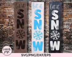 three snowboard signs in front of a brick wall with the words let it snow on them