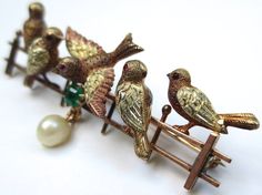 I absolutely love this precious bird brooch! This one is from my personal collection and being offered to you! Dating from the early 1900's. Made of 14K gold and hallmarked 585 on the back.. The piece has been tested to ensure the golds purity. There is a combination of yellow and rose gold used. Measuring 2 inches long by 1/2 an inch wide. The combined total weight is 6.8 grams. Five song birds are perched on a fence. All striking different poses with the center birds wings outstretched. There Elegant Bird Design Brooches For Gift, Birds Wings, Pearl Rings Vintage, Song Birds, Nouveau Jewelry, Different Poses, Bird Wings, Gold Cocktail Ring, Gold Cocktail