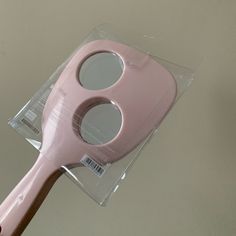 a close up of a pink toothbrush in a package