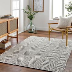 a living room with white walls and wooden furniture, including a large rug on the floor