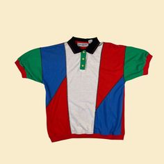 Vintage polo shirt, manufactured ca. 1990s by Goola Gong. This short sleeve shirt features a unique patchwork color-block design, with bright red, blue, green and black shapes. Size M. We believe this was originally a women's piece, but could be worn by anyone today (if the measurements work)!    - Time Period: 1990s  - Brand: Goola Gong  - Size: M  - Colors: Red, blue, white, green, black  - Materials: Polyester, cotton  - Made in: Taiwan R.O.C.  - Condition: In good, vintage condition with som Multicolor Short Sleeve Shirt With Color Block, Sporty Multicolor Short Sleeve Tops, Multicolor Collared Color Block Tops, Multicolor Short Sleeve Color Block Tops, 90s Style Multicolor Short Sleeve Shirt, Vintage Short Sleeve Tops With Patchwork, Green Short Sleeve Color Block Shirt, Short Sleeve Cotton Polo Shirt With Color Block, Casual Collared T-shirt With Patchwork