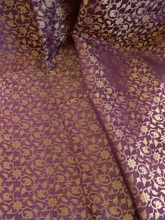 This listing is for 1 yard of beautiful purple golden brocade silk. Fabric Width: 42-43” wideFabric Type: Semi Silk BrocadeThroughout history, brocade was a fabric of luxury worn by nobility in various cultures, from India to Korea. Brocade is a heavy fabric similar to jacquard with a raised pattern or floral design. Traditionally the pattern was produced with gold or silver thread said to be of such superb quality that they could be woven into the fabric of gold and silver. Traditional Jacquard Embroidered Fabric For Wedding, Elegant Ceremonial Dupatta With Woven Motifs, Traditional Wedding Jacquard Embroidered Fabric, Elegant Brocade Dupatta With Woven Motifs, Elegant Brocade Blouse Piece With Motifs, Traditional Jacquard Embroidered Fabric For Festive Occasions, Traditional Jacquard Embroidered Fabric For Festive, Traditional Jacquard Dupatta For Festive Occasions, Gold Silk Dupatta With Woven Motifs