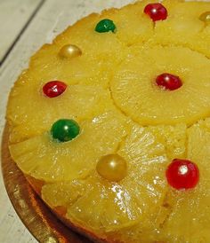 a pineapple upside down cake with candy on it's top, sitting on a cutting board