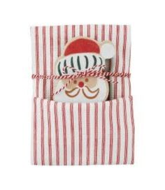 a red and white striped gift bag with a santa clause on it's face