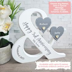 personalized wedding gifts for the couple on their anniversary or special day are displayed in front of a vase with flowers