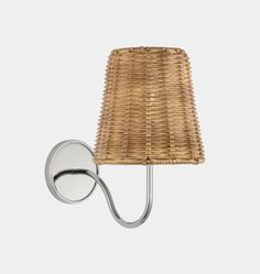 a wall light with a rattan shade on it's side and a white background