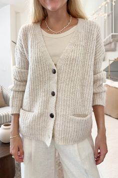 The Isabella Knit Cardigan is a beautiful oatmeal color, that will mix and match beautifully with all of your fall wardrobe! It has the sweetest wooden buttons that truly add a special touch to the piece! Featuring a button down front, v neckline, knit fabric, oatmeal color, and a true to size fit. Style the piece with linen pants and a tank top while out running errands! Details & Sizing V neckline Knit fabric Oatmeal color True to size fit Gabriella is wearing a size S/M Fabric 73% Acrylic 14% Cream Knit Button-up Cardigan, Beige Knit V-neck Cardigan, Everyday Beige V-neck Outerwear, Everyday Cream V-neck Outerwear, Cozy Everyday Cardigan With Buttons, Everyday Cozy Cardigan With Buttons, Beige V-neck Cardigan With Button Closure, Cream Cardigan With Button Closure For Fall, Neutral Soft Knit Cardigan