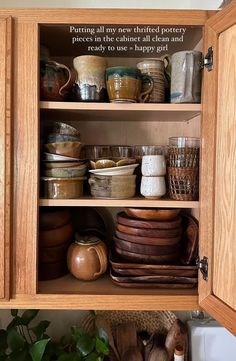 a wooden cabinet filled with lots of dishes