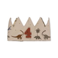 the number four with dinosaurs on it sits in front of a white background and is made out of fabric