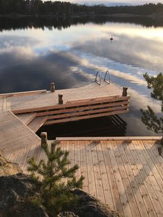 a wooden dock sitting on top of a lake