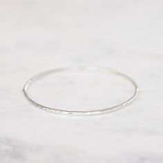 This fine hand forged bangle has a hammered finish. Beautiful worn on its own, or layered with our other fine bangles. Approx. width: 2mm. Approx. gold weight: 7 grams in 9ct. Adjustable Hammered Wedding Bangle, Minimalist Hammered Bangle For Everyday, Minimalist Everyday Hammered Bangle, Adjustable Hammered Yellow Gold Bangle, Elegant Hammered Brass Bangle, Instagram Icons, Caicos Islands, Pitcairn Islands, Turks And Caicos Islands