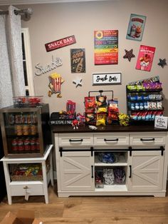 a kitchen filled with lots of food and snacks on top of wooden floored floors