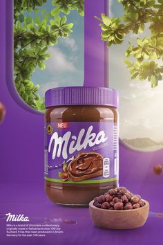 a jar of nut butter next to a bowl of nuts on a purple surface with trees in the background