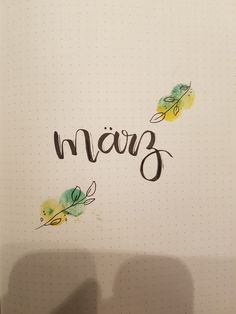 an open notebook with writing on it that says, maig in cursive writing