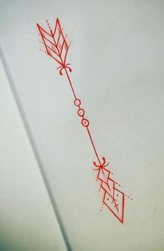 an arrow drawn on the side of a white sheet with red ink and some black dots