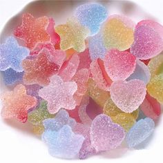 a bowl filled with gummy bears sitting on top of a table