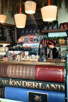 there are three books stacked on top of each other in front of the counter at this coffee shop