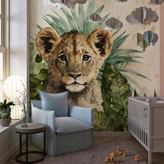 a baby's room with a lion mural on the wall next to a crib